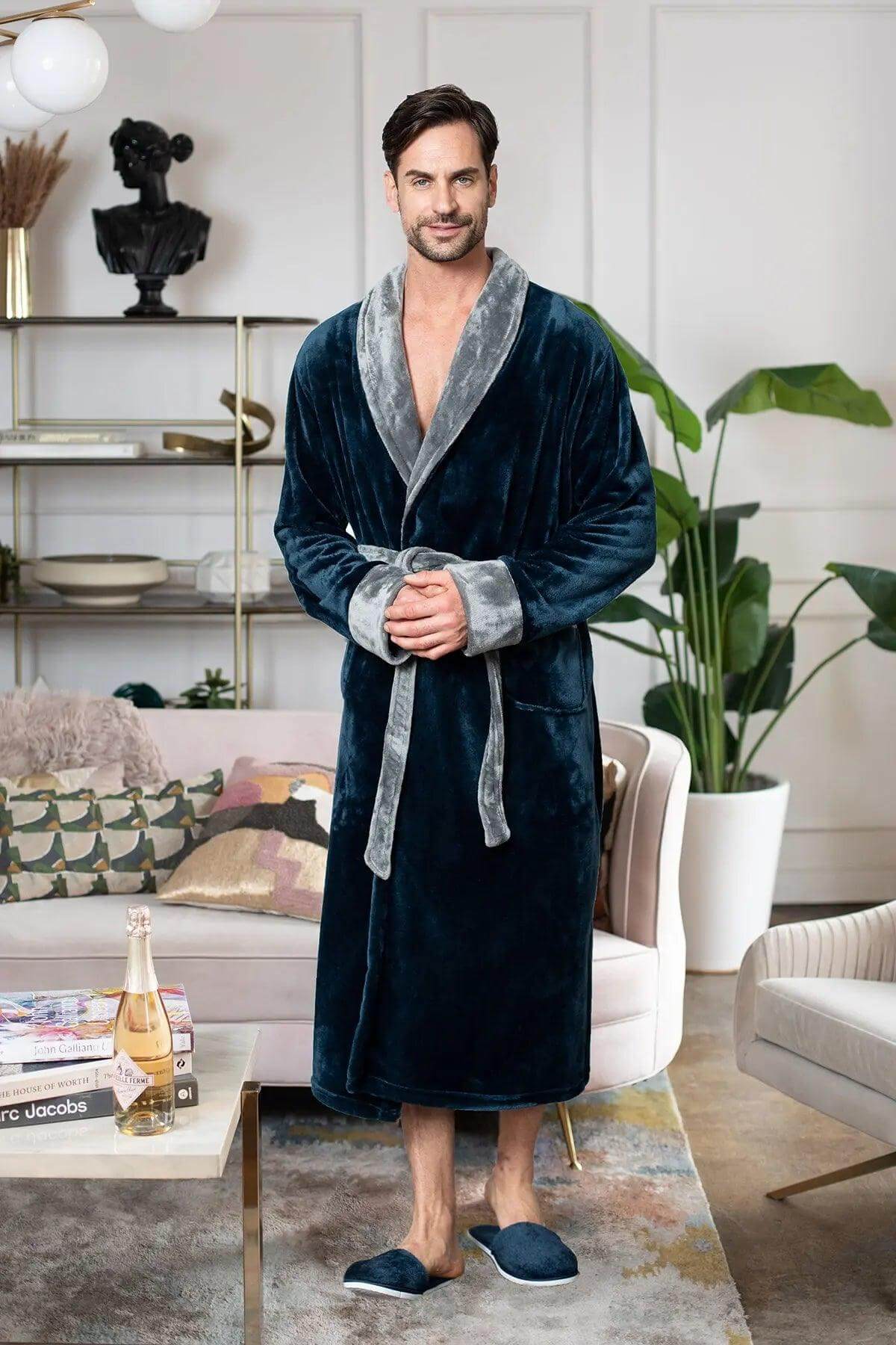 Man wearing a dark blue velvet robe in a living room setting