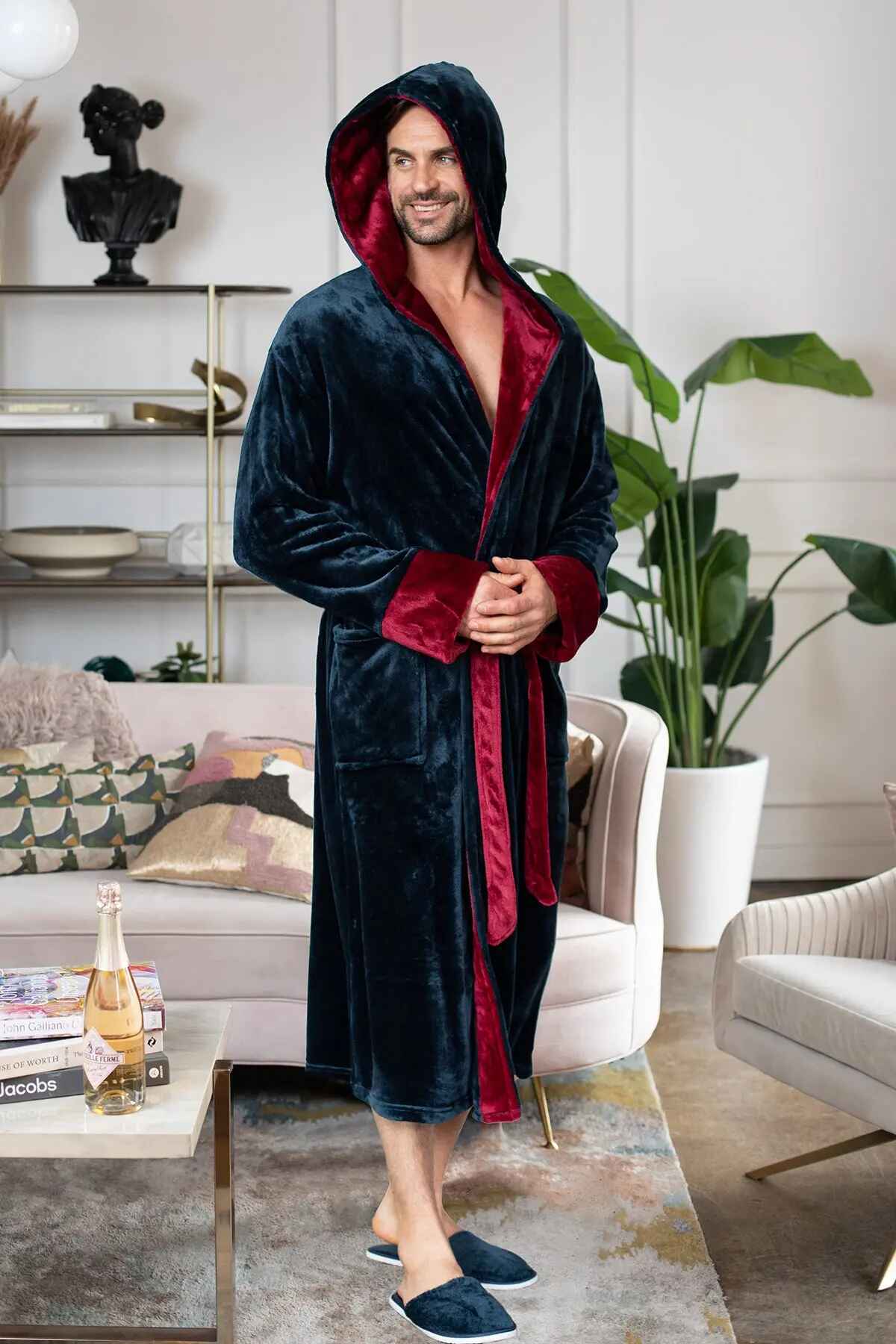 Man wearing a dark blue and red robe in a living room setting